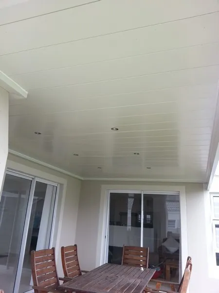 White aluminium ceiling over a covered patio