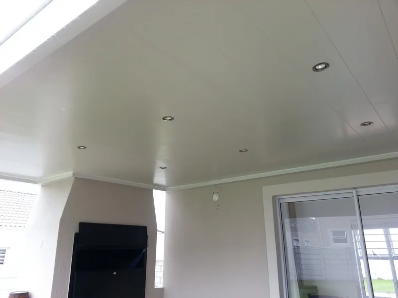 Aluminium ceiling with downlighters over an outdoor dining area