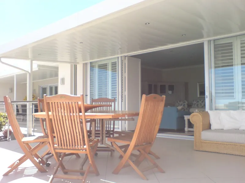 Clean white ceiling panels over a veranda