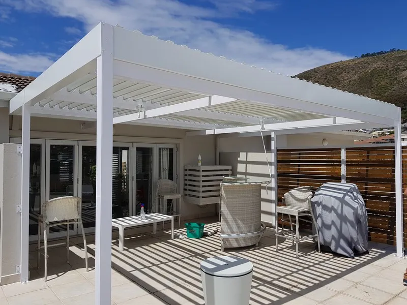 Adjustable louvre awning installation over a patio