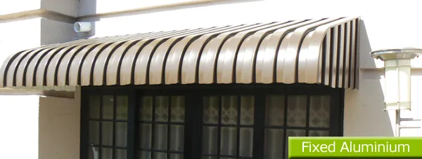 Fixed aluminium awnings over the windows of a family home