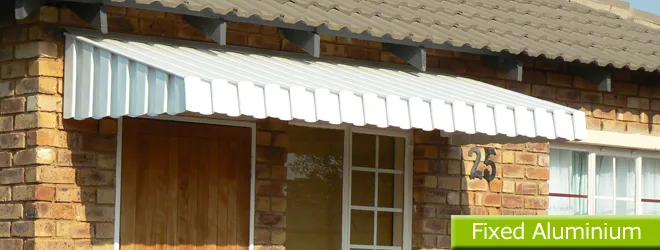 Fixed aluminium awning over a patio dining table