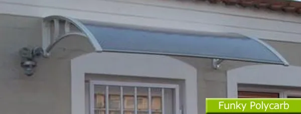 Curved bronze polycarbonate awning over a shop window