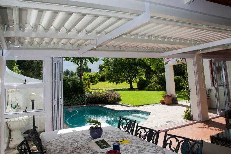 Louvre patio cover beside a swimming pool