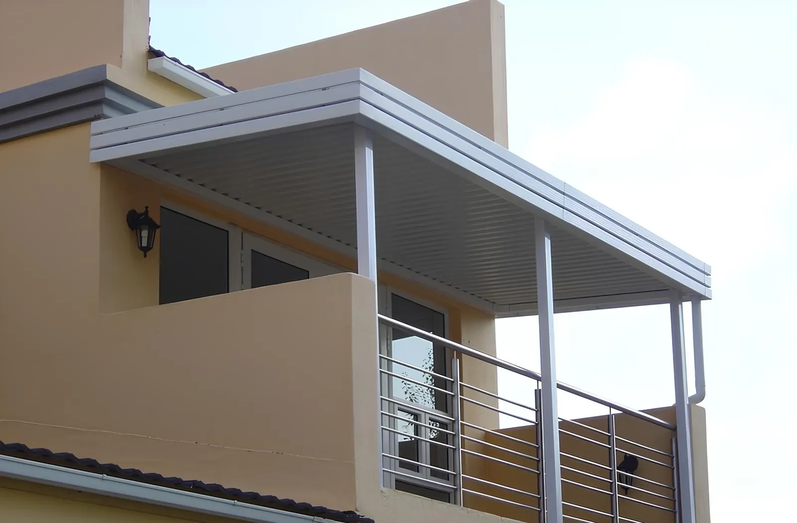 Fixed aluminium IBR patio cover over a first-floor balcony