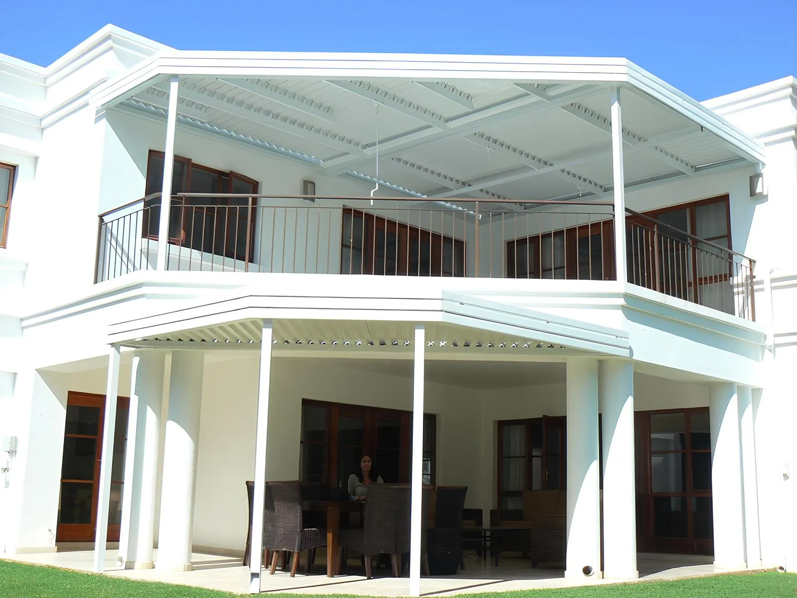 Louvre covers over the balcony and patio of a modern home