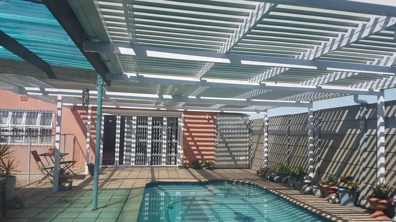 Aluminium cover over a jacuzzi and pool area
