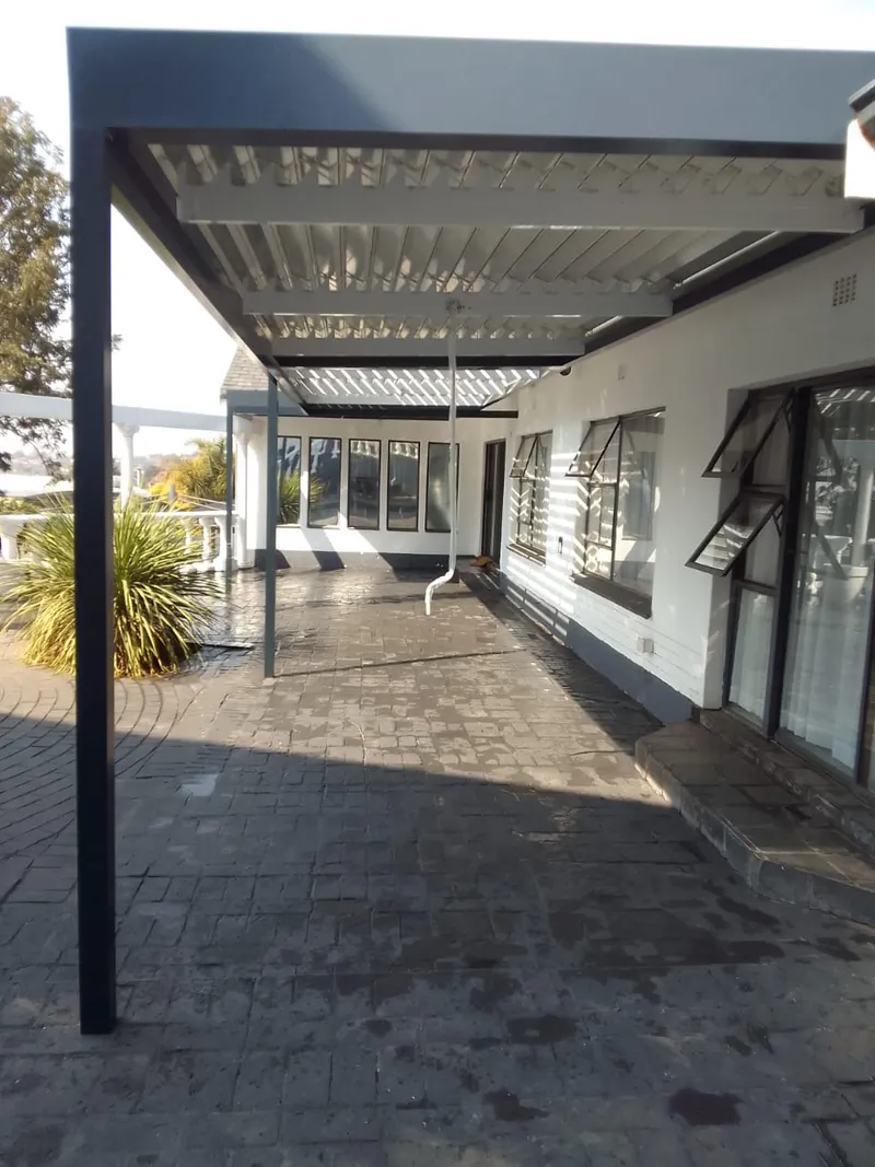 Long fixed aluminium awning running the length of a house