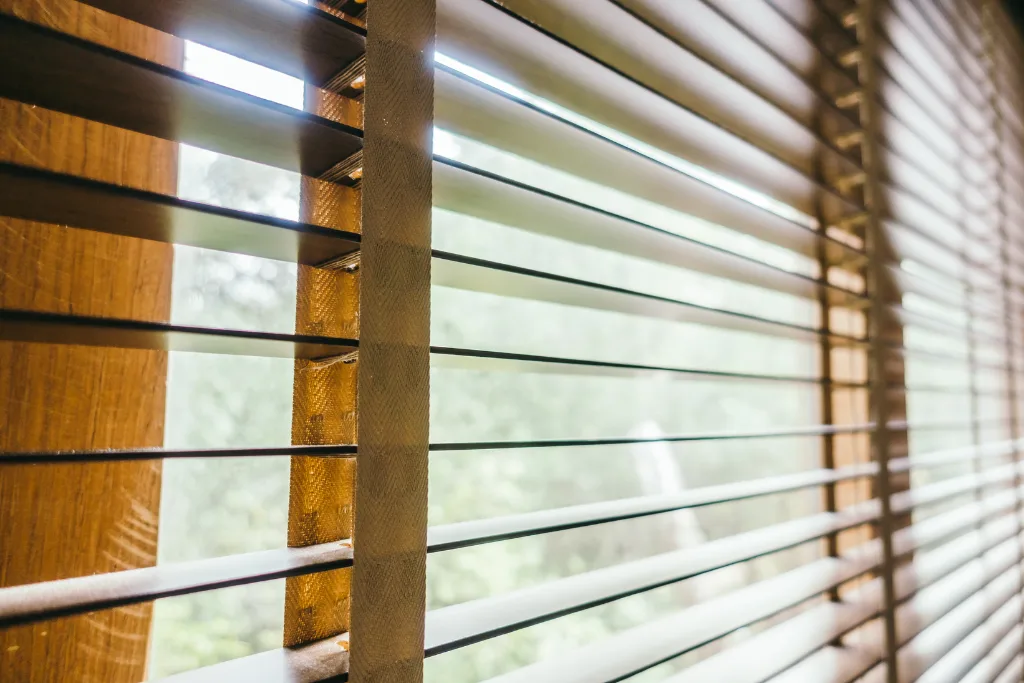 Cream canvas drop blinds lowered around a covered patio, keeping the wind off the seating area