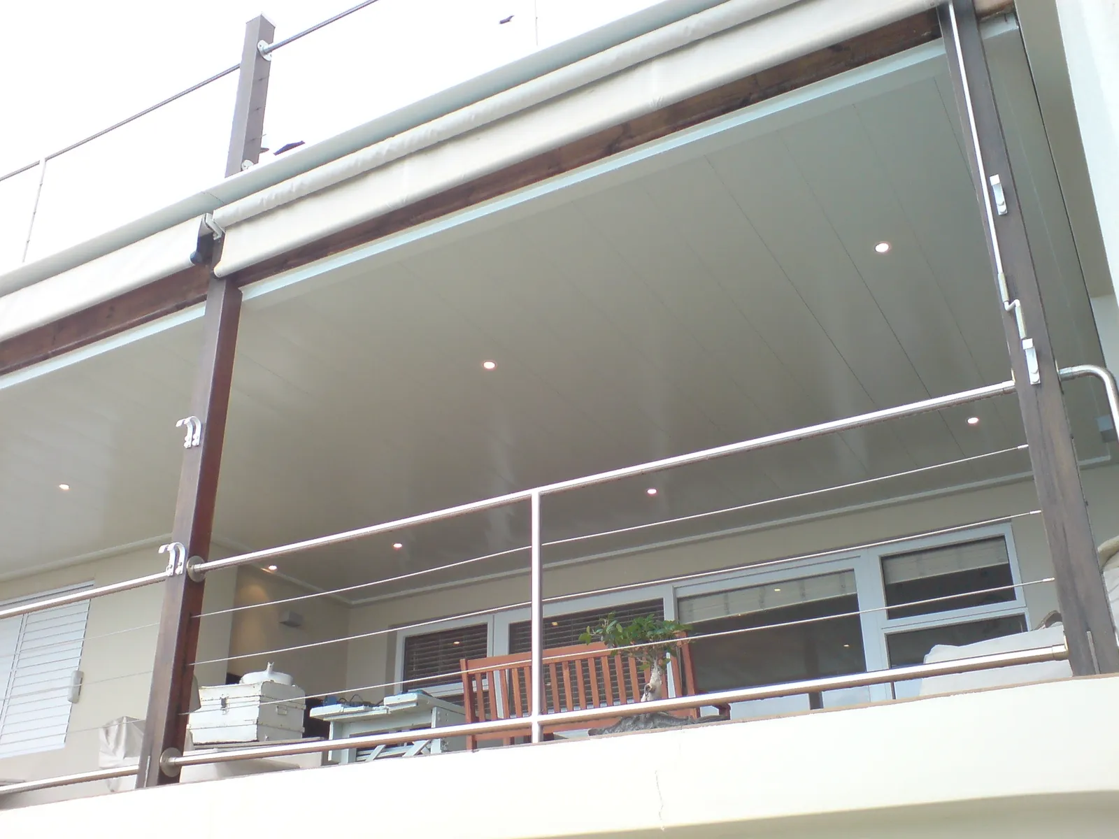 Double carport shielding vehicles from sun and hail