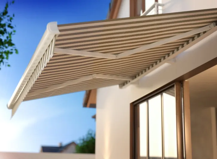 Canvas fold-arm awning extended over a window